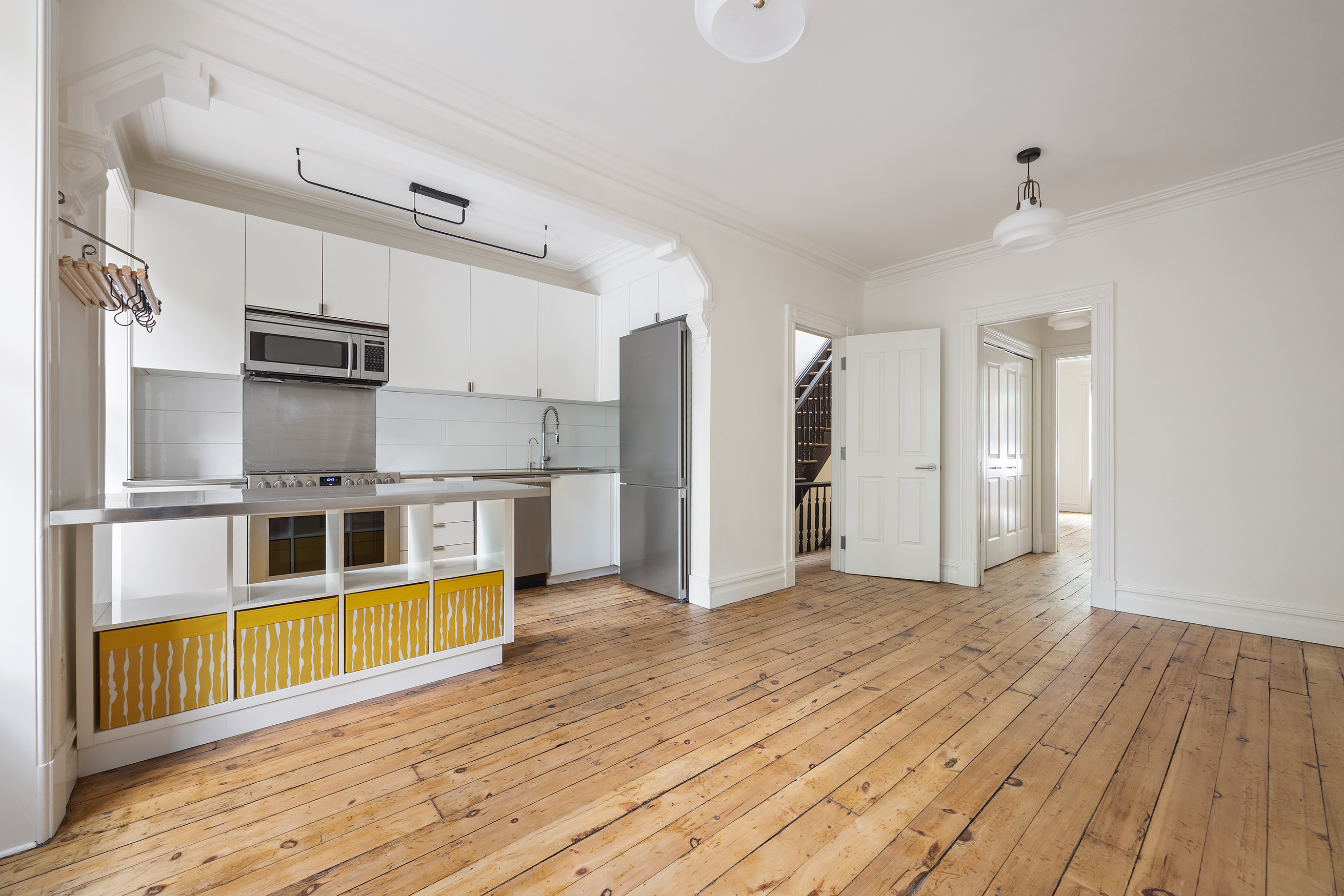64 Clifton Place, Unit 2 Brooklyn, NY 11238 - Photo 2 of 16 a view of a kitchen with wooden floor and a kitchen