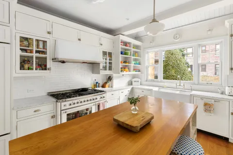 a kitchen with stainless steel appliances granite countertop a stove and a sink