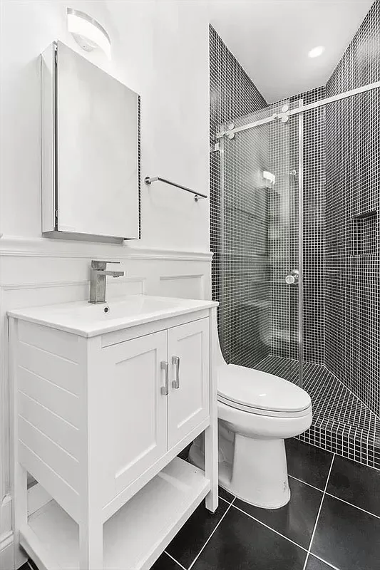 a bathroom with a sink toilet and shower