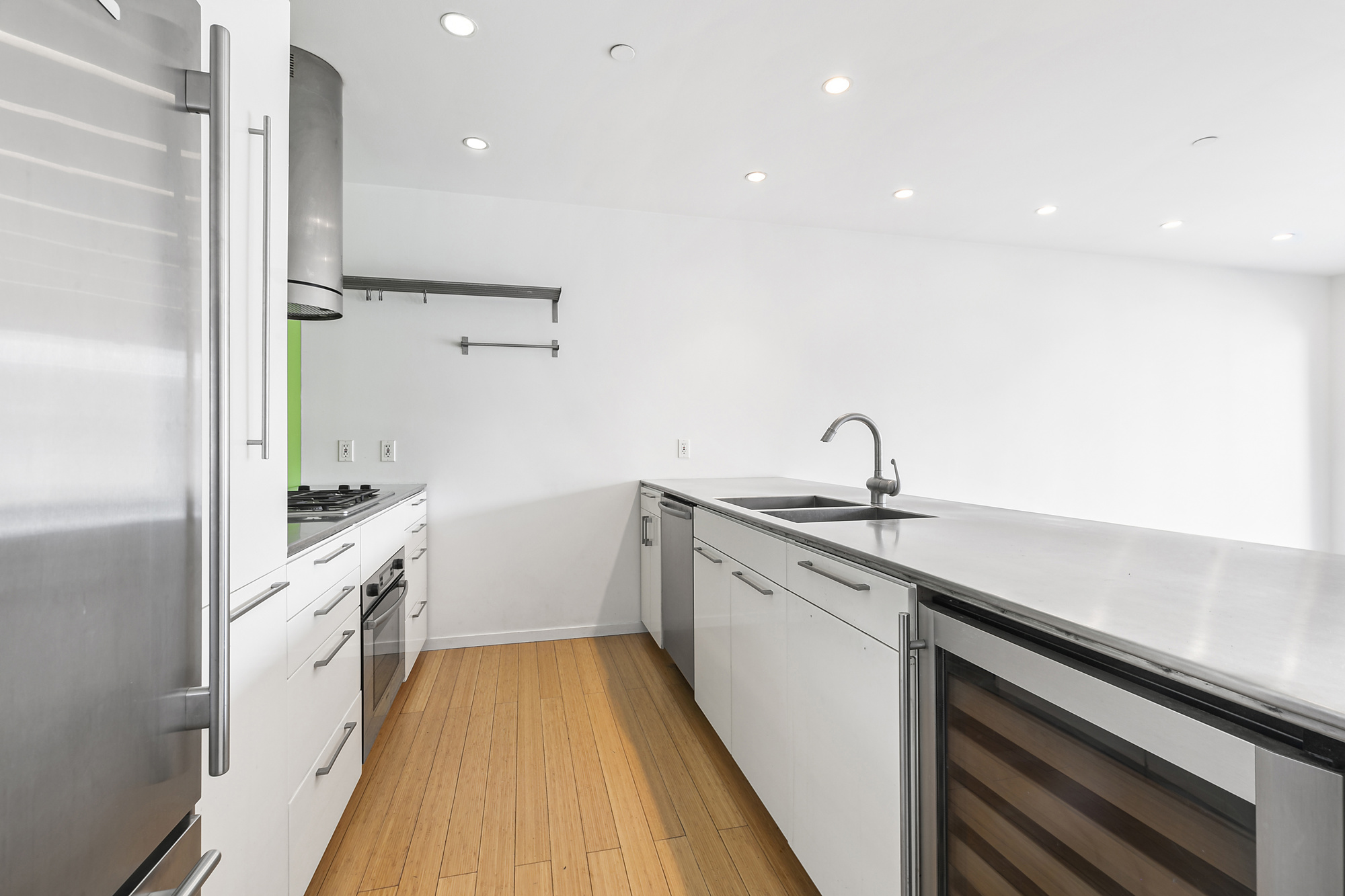 109 Norfolk Street, Unit 4 Manhattan, NY 10002 - Photo 2 of 7 a kitchen with a sink and refrigerator