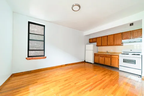 a view of a kitchen with wooden floor and electronic appliances