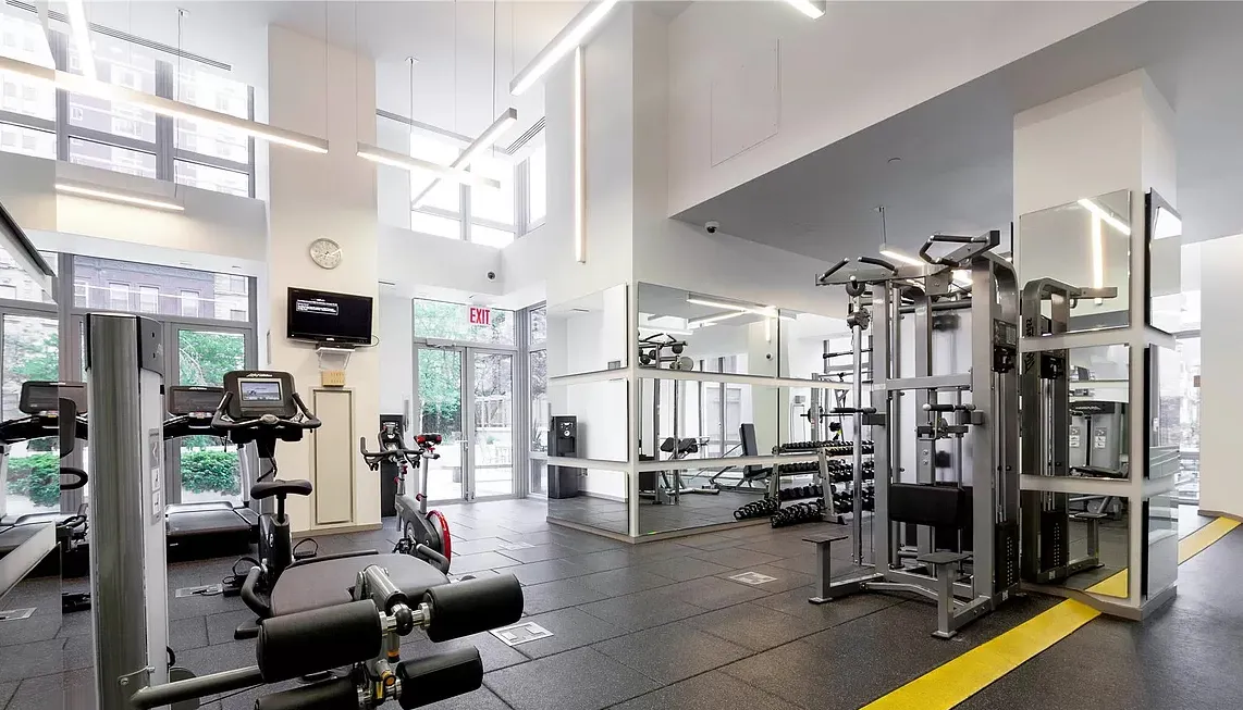 a gym room with lots of gym equipment