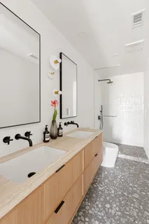a bathroom with a double vanity sink double mirror and bathtub