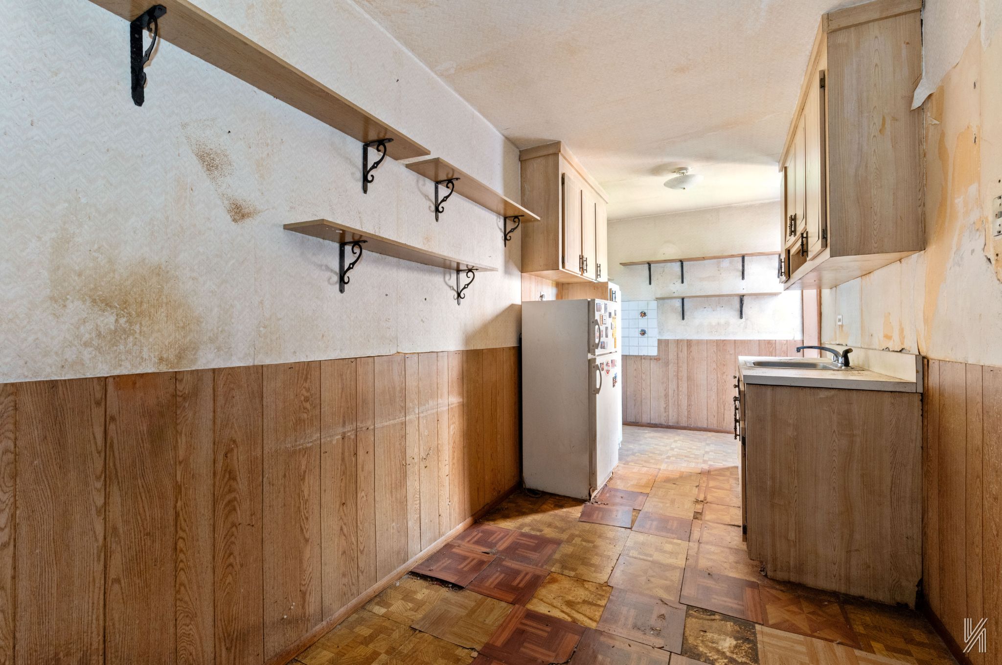33-04 91st Street, Unit 5L Queens, NY 11372 - Photo 8 of 17 a view of a kitchen with refrigerator and wooden cabinets
