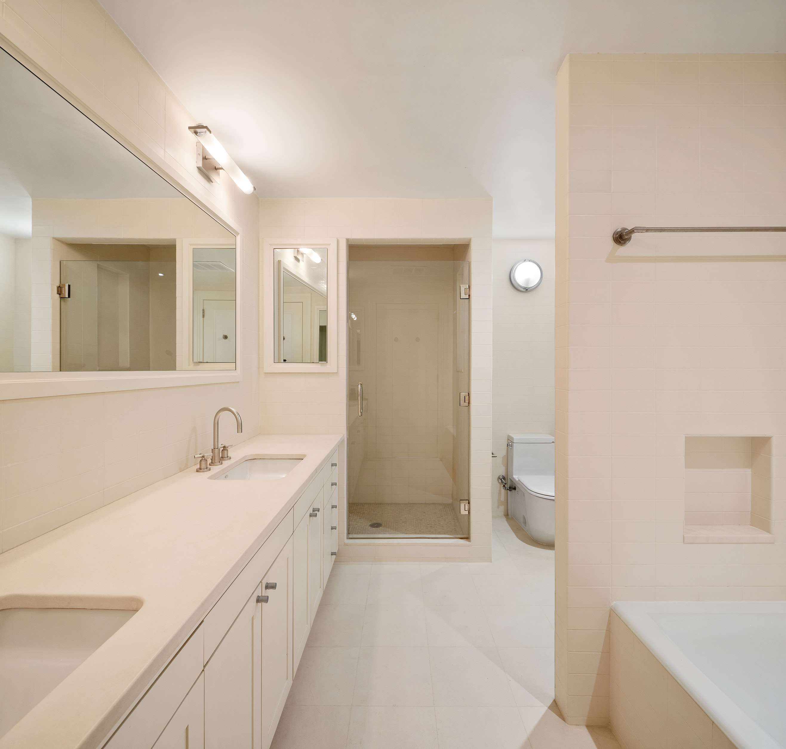 27 North Moore Street, Unit 10D Manhattan, NY 10013 - Photo 21 of 30 a spacious bathroom with a double vanity sink a toilet and a mirror