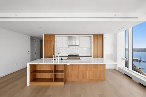 a view of kitchen with wooden floor and electronic appliances