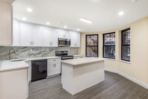 a kitchen with a stove top oven sink and cabinets