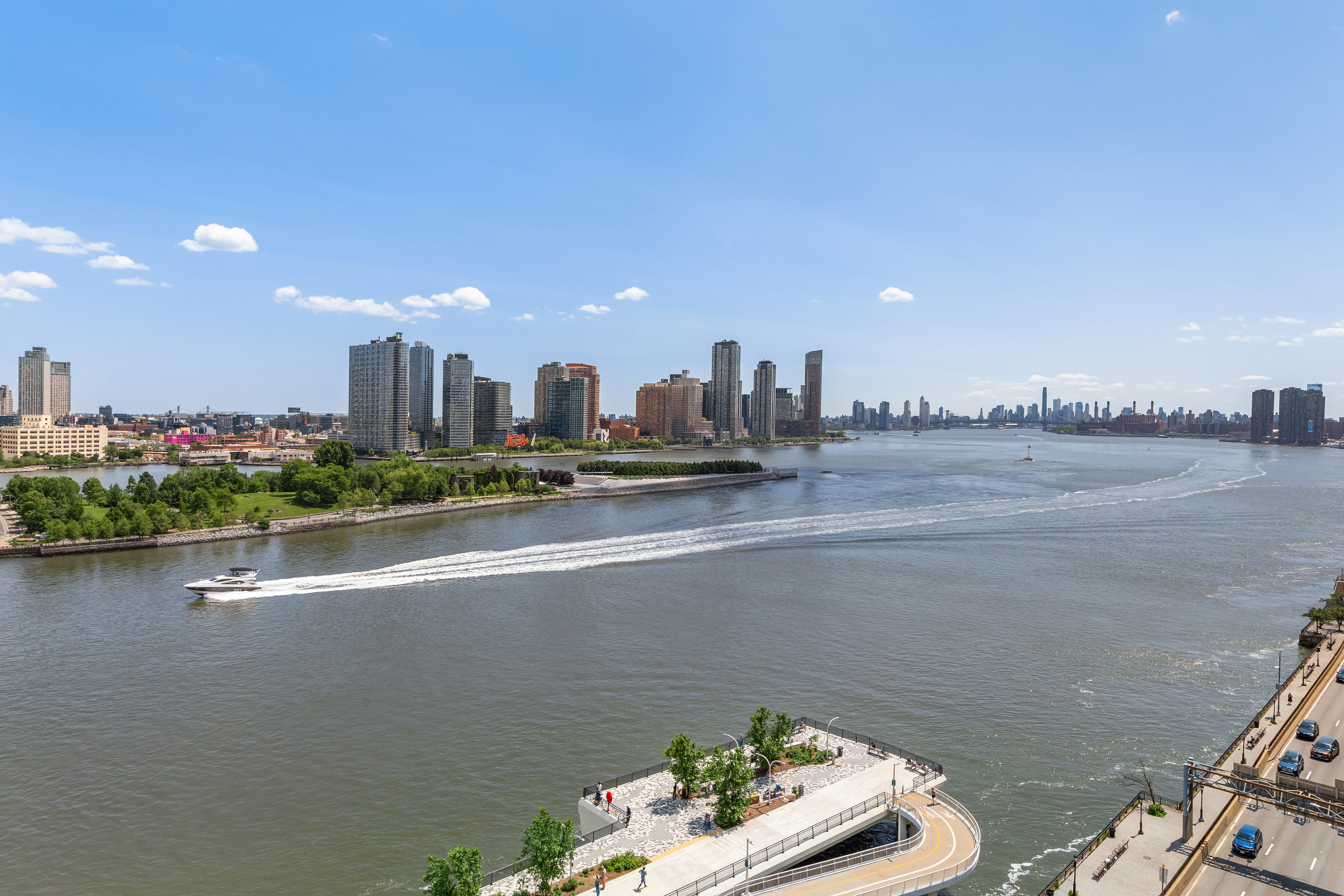 45 Sutton Place South, Unit 14N Manhattan, NY 10022 - Photo 13 of 19 a view of a city skyline from a balcony