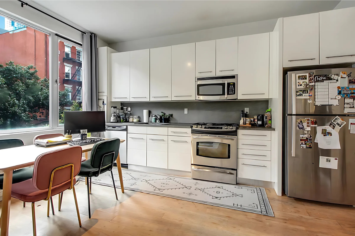 517 West 46th Street, Unit 307 Manhattan, NY 10036 - Photo 5 of 10 a kitchen with a stove a sink and a refrigerator