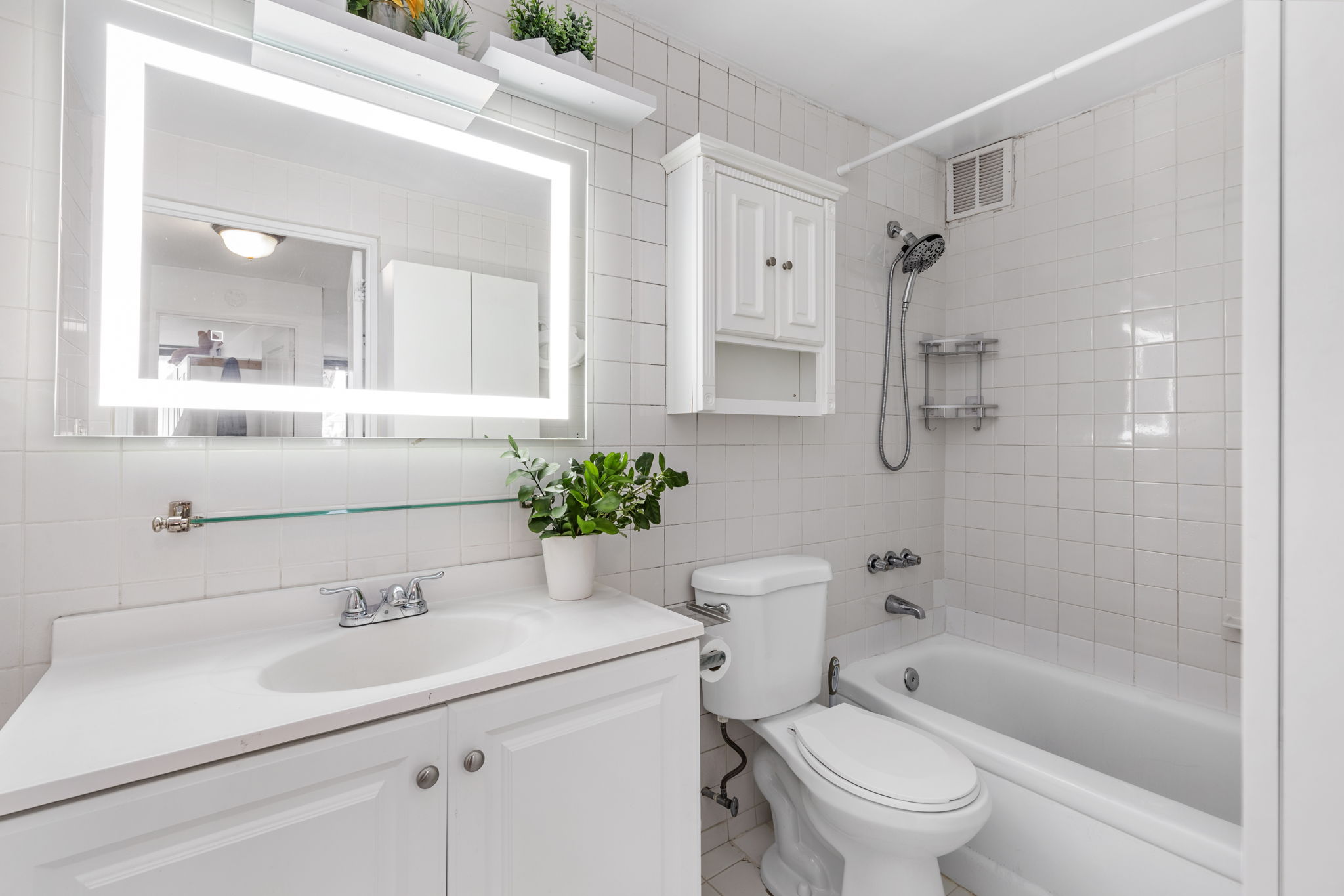 11-01 162nd Street, Unit 3D Queens, NY 11357 - Photo 6 of 16 a bathroom with a sink toilet a mirror and shower