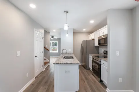 a kitchen with refrigerator and window