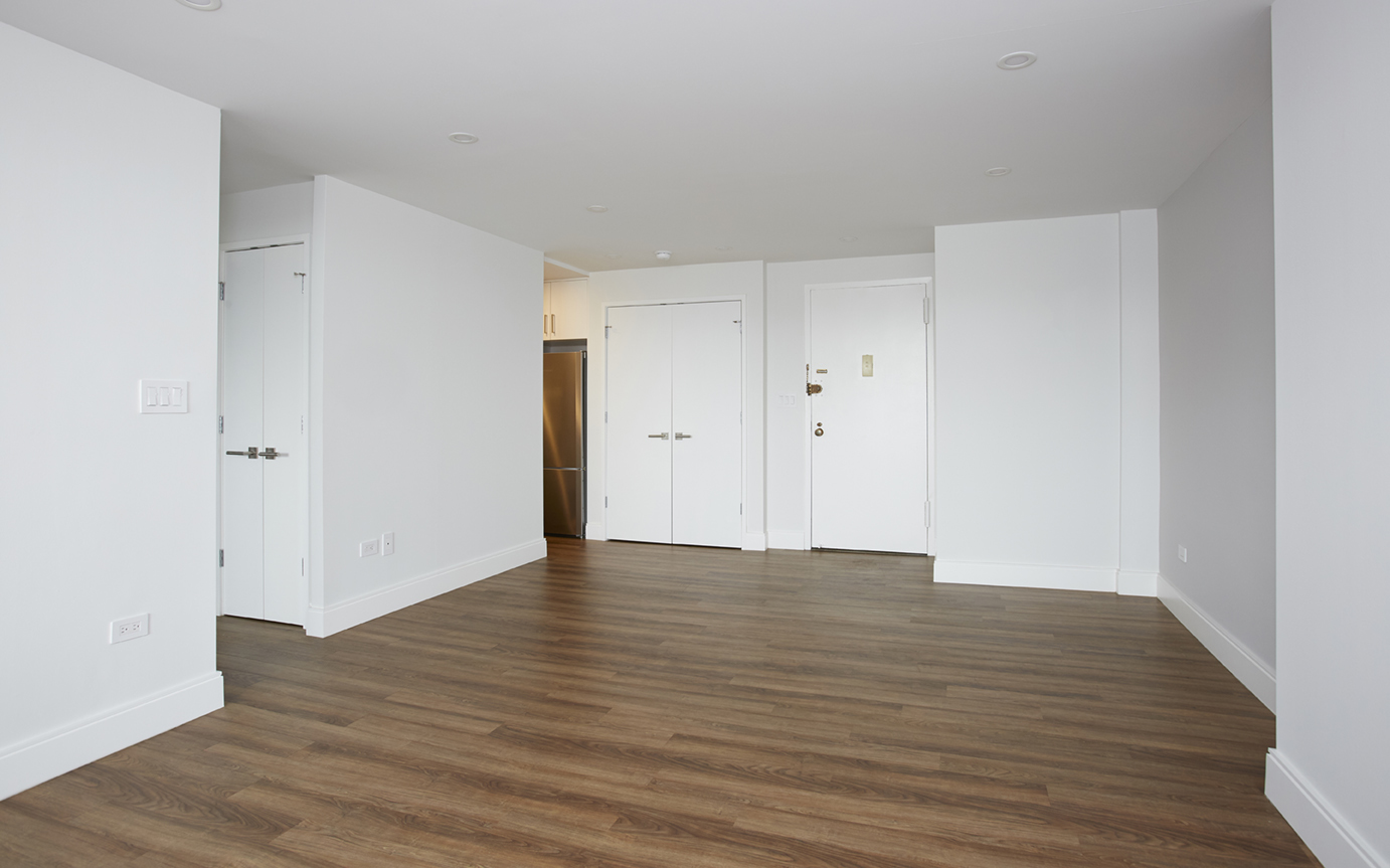 333 Pearl Street, Unit 26M Manhattan, NY 10038 - Photo 3 of 15 a view of an empty room with wooden floor