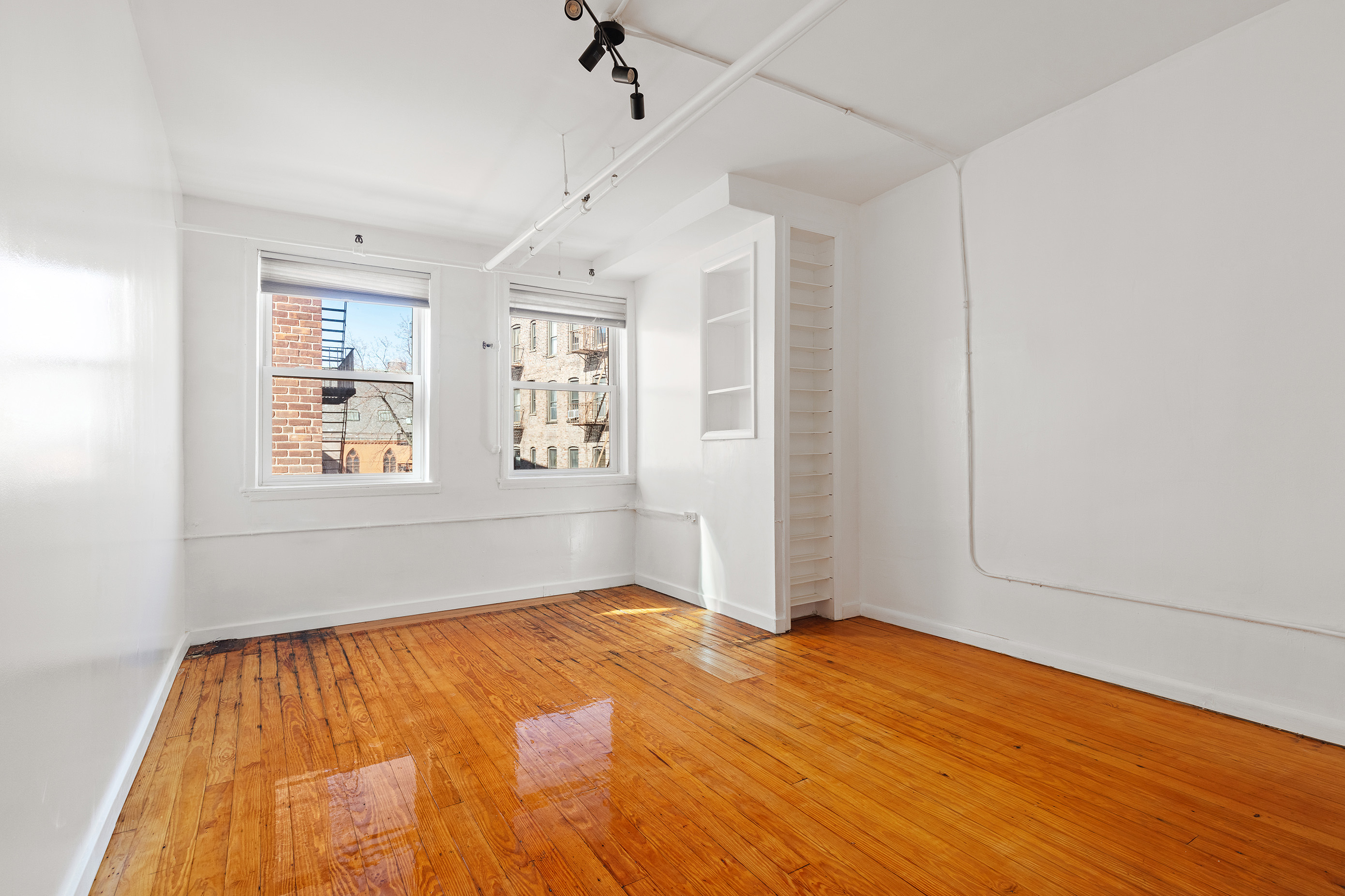 71 8th Avenue, Unit 4R Manhattan, NY 10014 - Photo 3 of 5 a view of empty room with wooden floor and fan