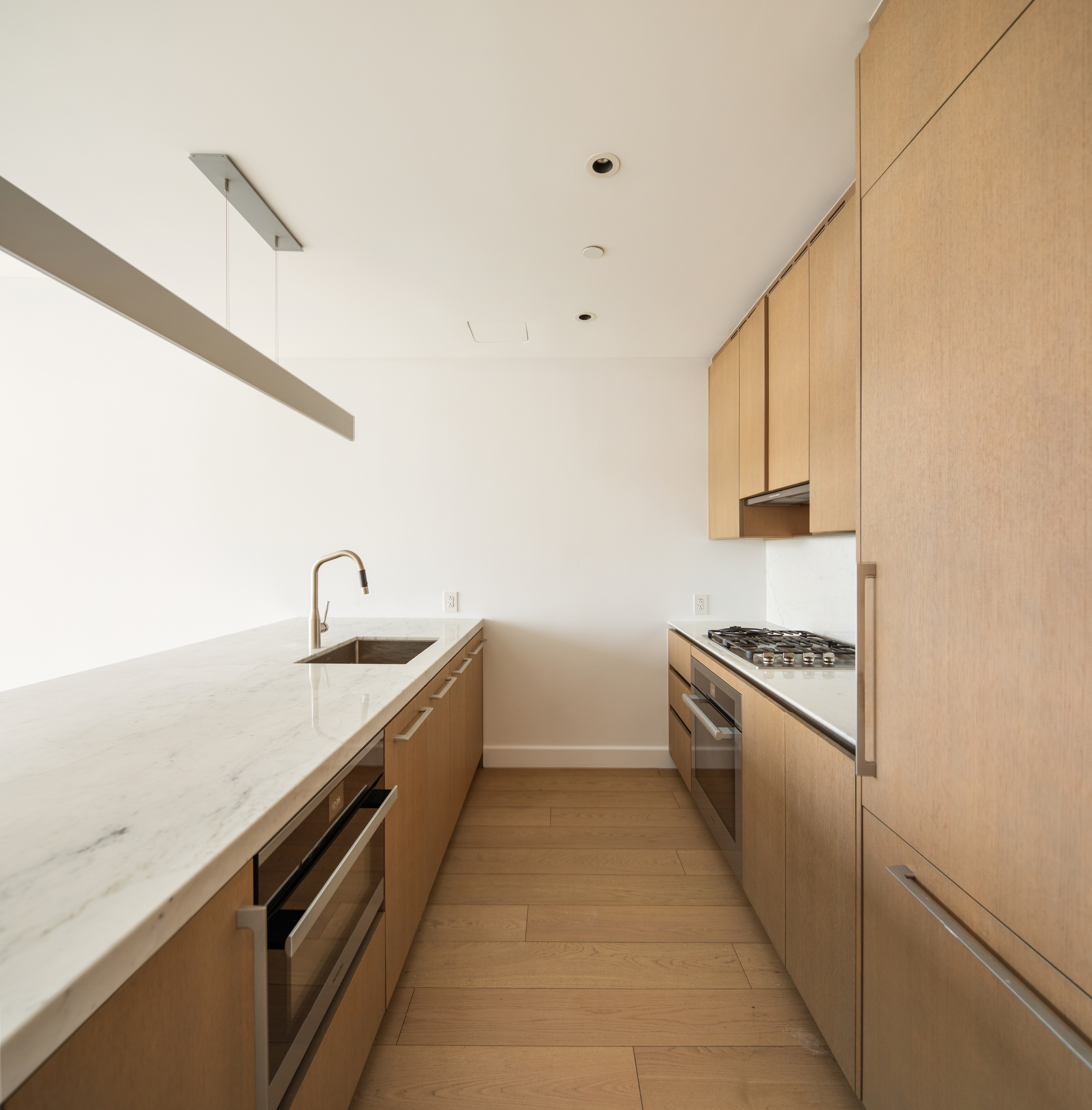 15 Hudson Yards, Unit 37F Manhattan, NY 10001 - Photo 4 of 8 a large kitchen with a stove and white cabinets