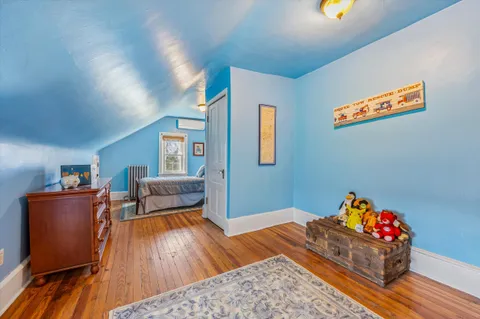 a view of a bedroom with furniture and a large window