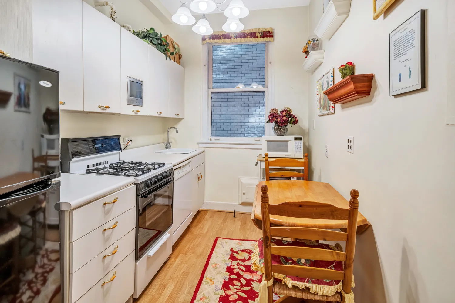 a kitchen with a stove and white cabinets