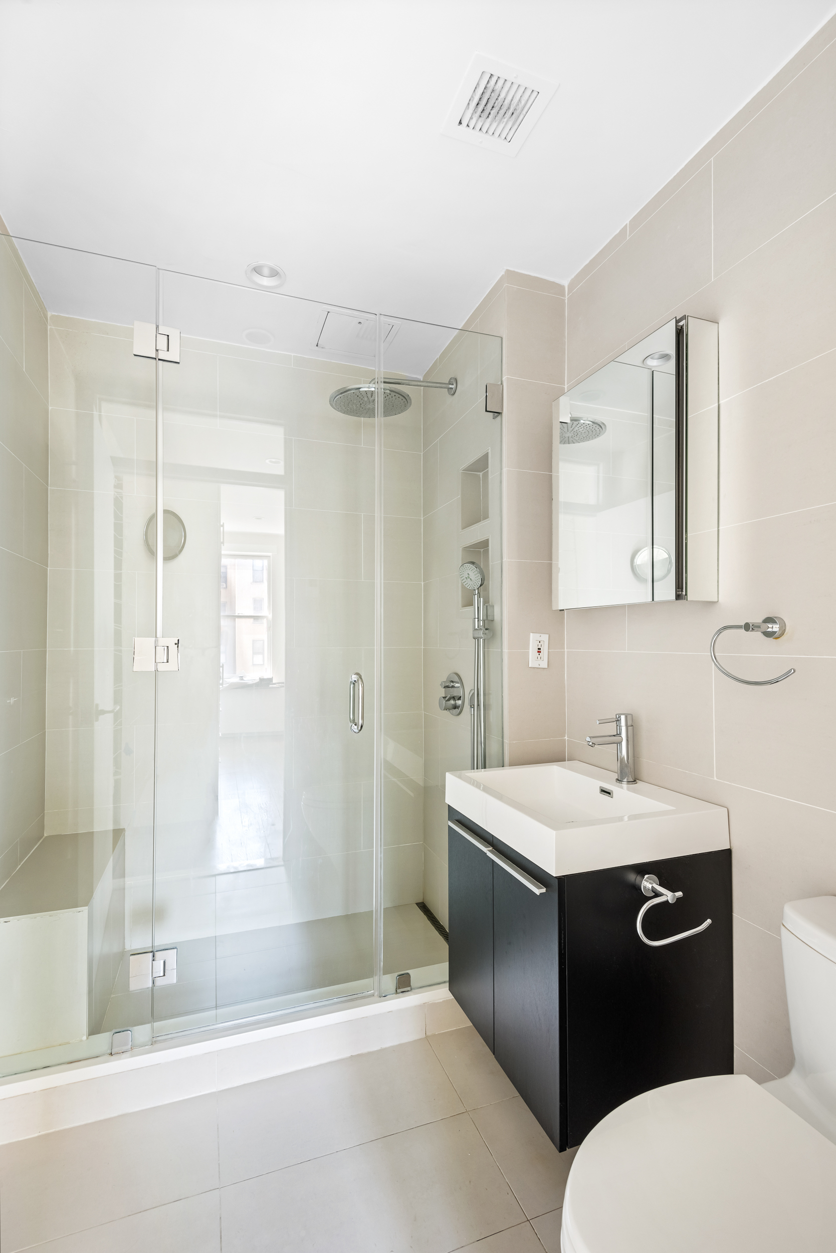 176 Mulberry Street, Unit 5 Manhattan, NY 10013 - Photo 9 of 12 a bathroom with a sink a toilet and shower