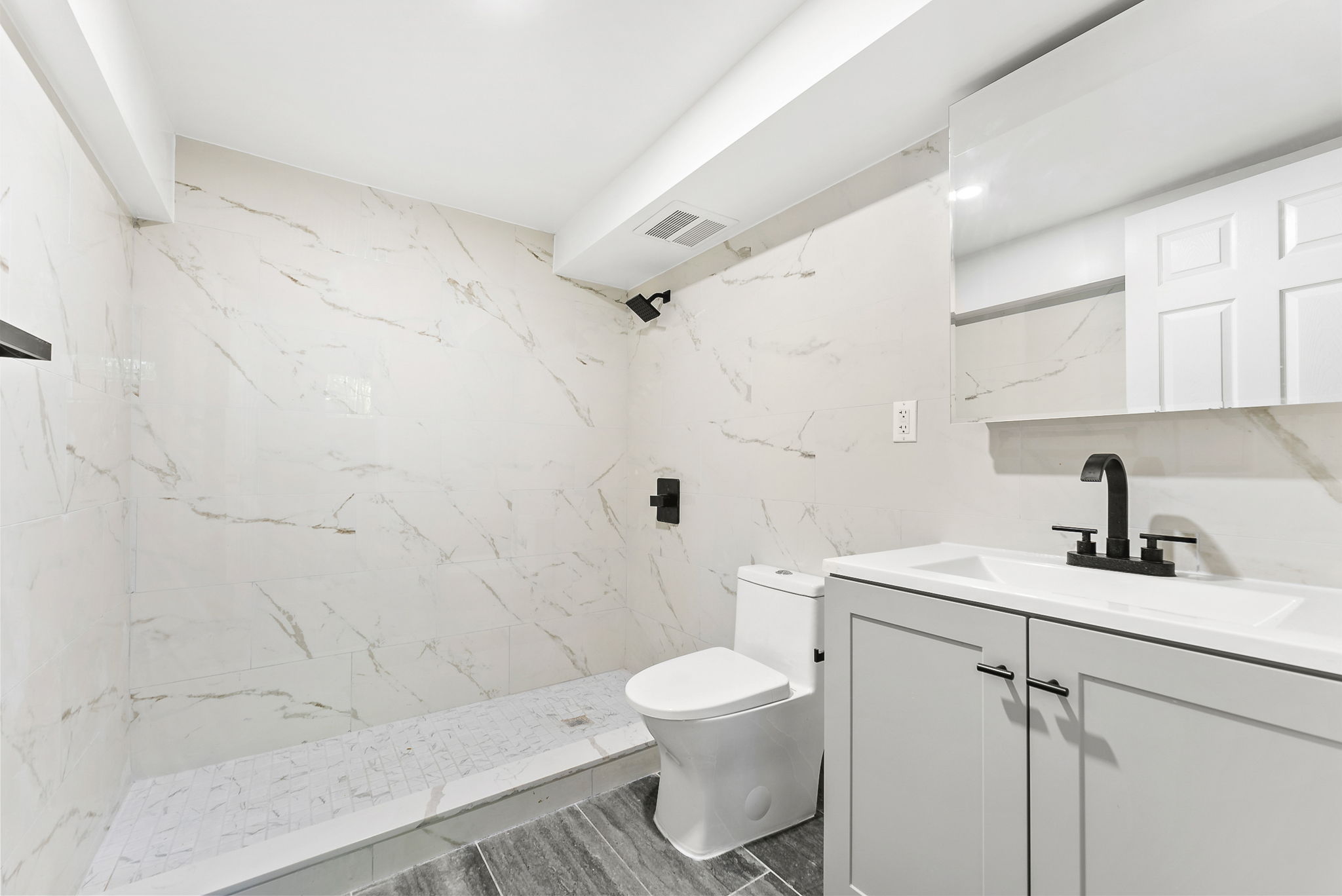 1414 30th Road Queens, NY 11102 - Photo 11 of 16 a bathroom with a sink a toilet and shower
