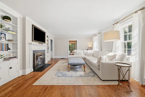 a living room with furniture fireplace and flat screen tv