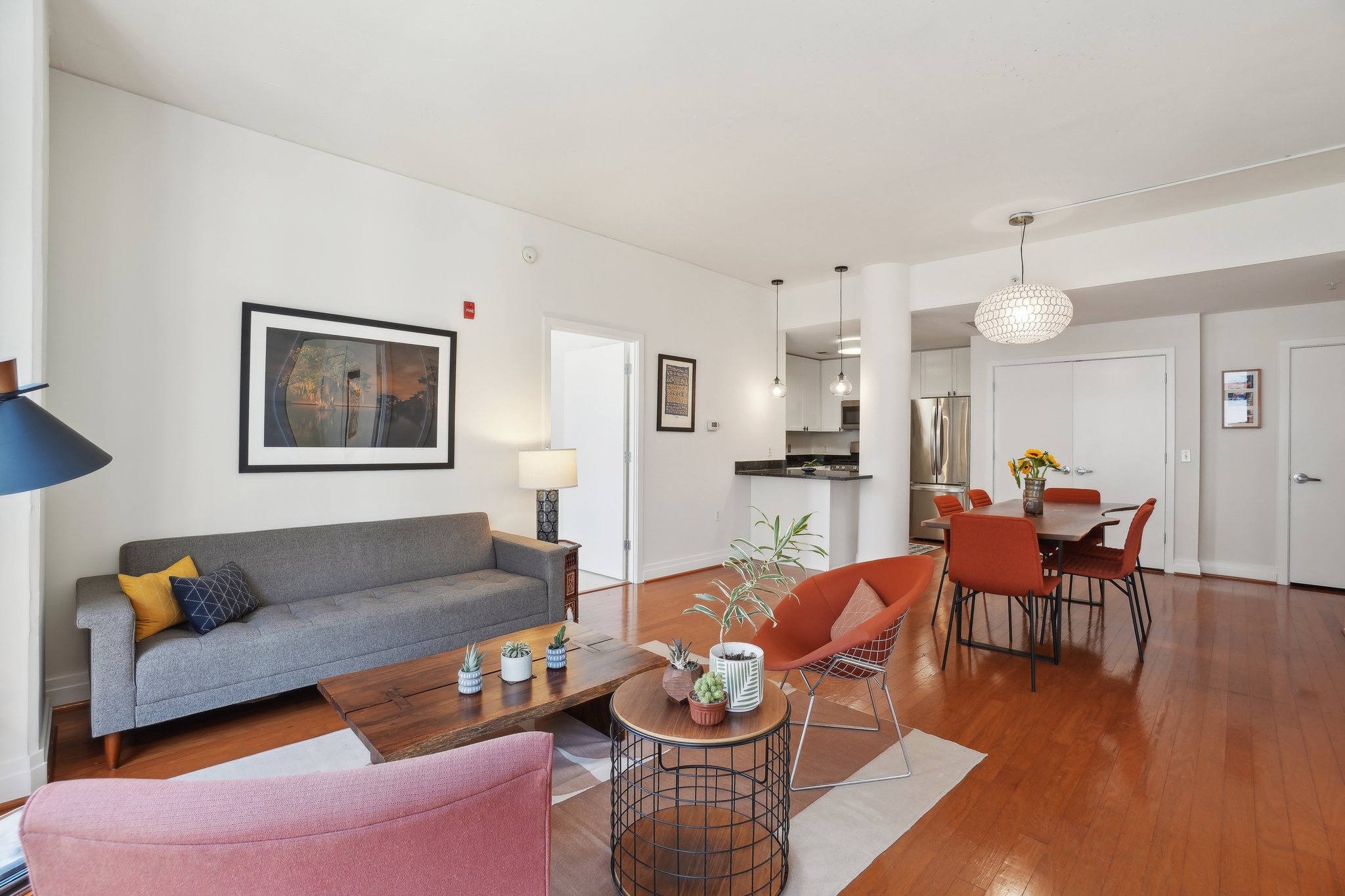 2120 Vermont Avenue Northwest, Unit 309 Washington, DC 20001 - Photo 7 of 26 a living room with furniture and a dining table with wooden floor