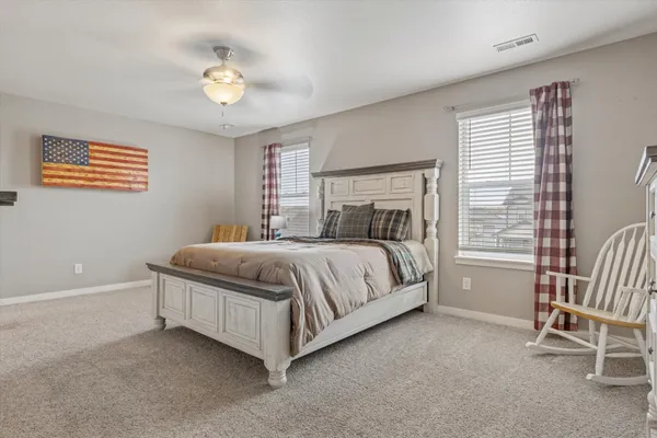 a bedroom with a bed and a chair