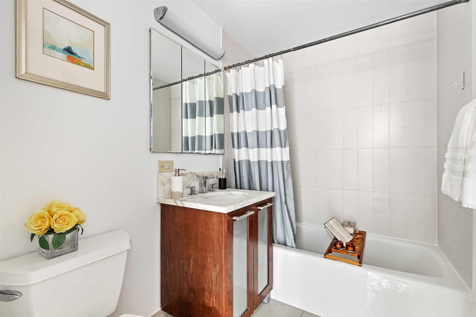 121 East 23rd Street, Unit 4H Manhattan, NY 10010 - Photo 5 of 12 a bathroom with a sink toilet and shower
