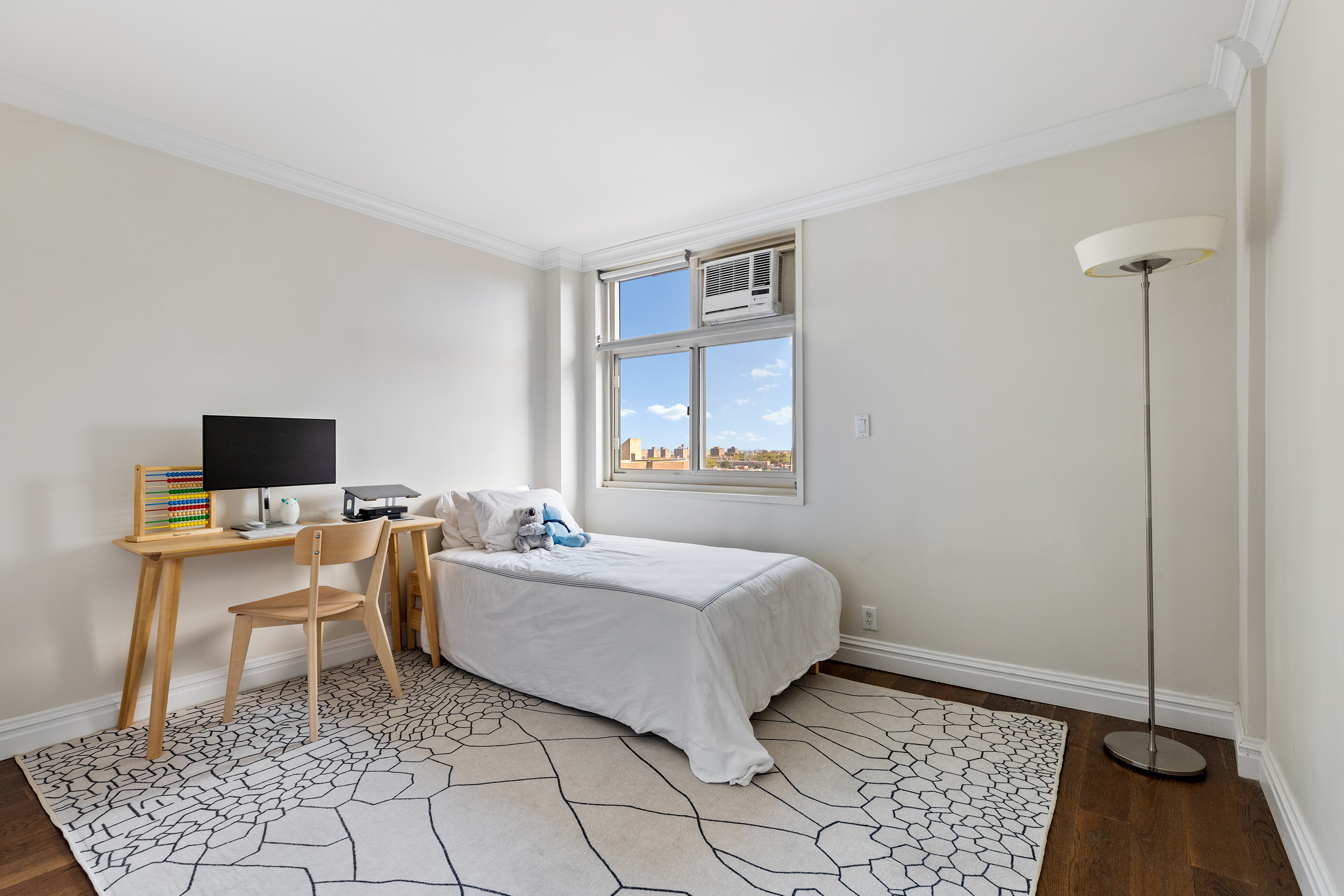 575 Main Street, Unit 1312 Manhattan, NY 10044 - Photo 15 of 25 a living room with a couch and a flat screen tv