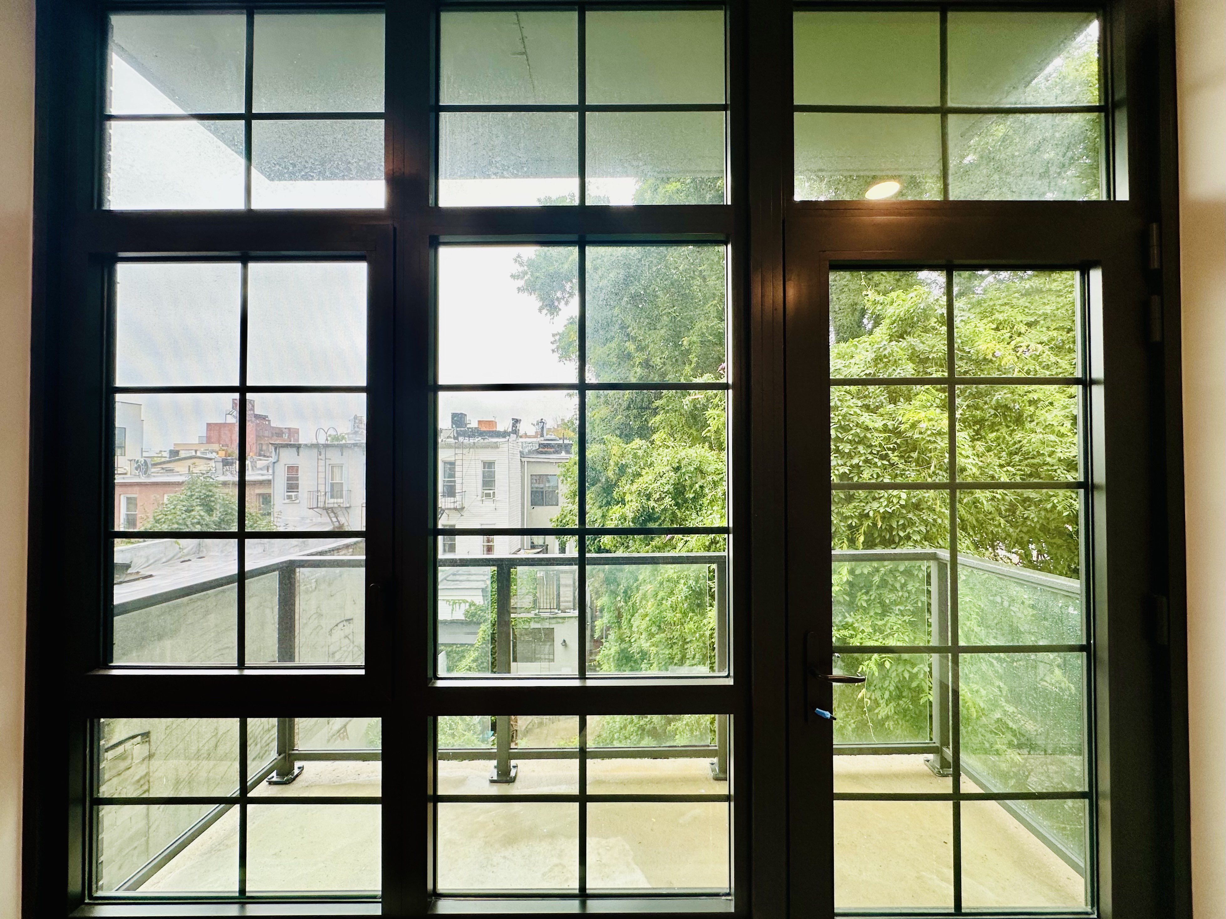 23 Bleecker Street, Unit 4E Brooklyn, NY 11221 - Photo 4 of 11 a view of a glass building from a window
