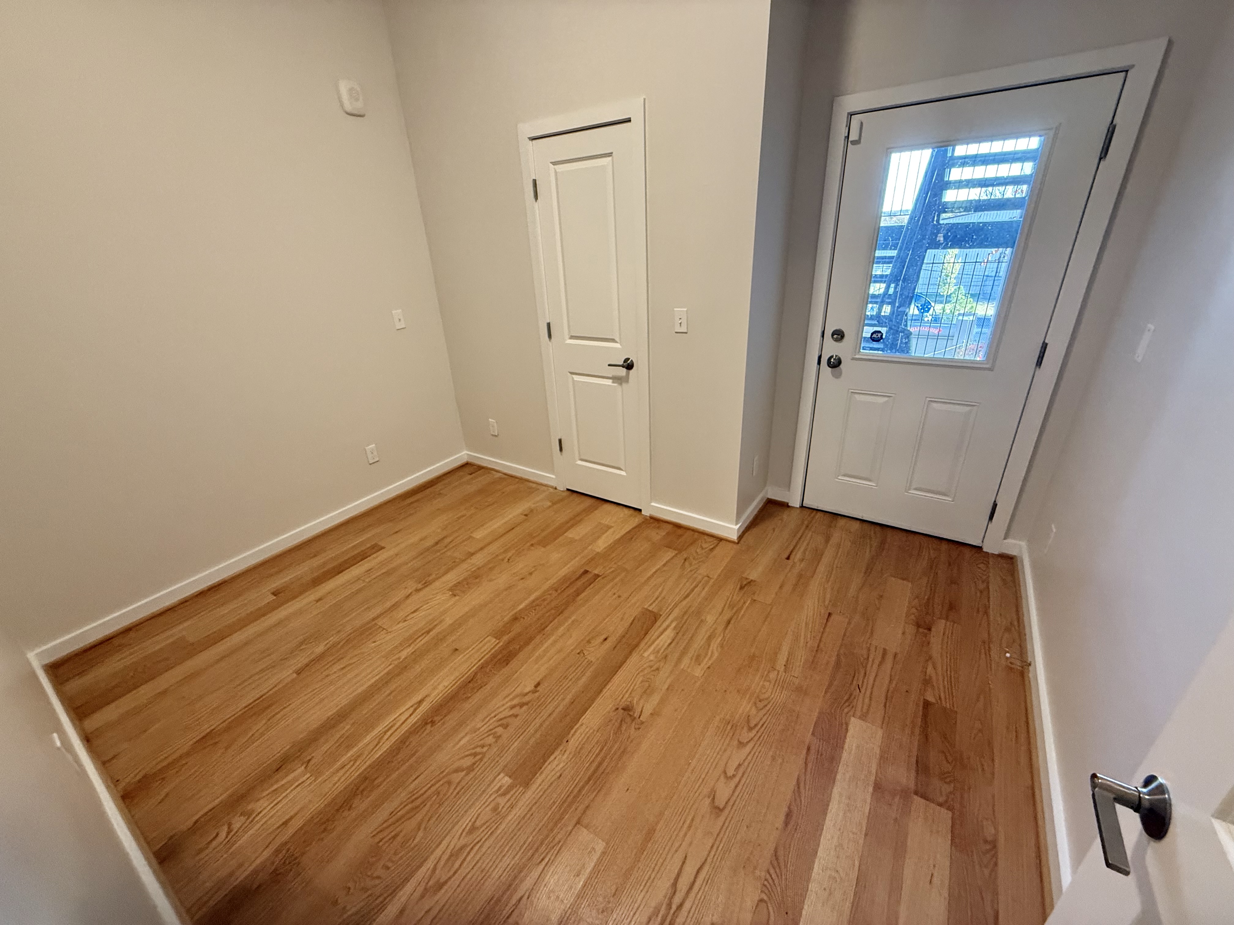 2009 Benning Road Northeast, Unit 2 Washington, DC 20002 - Photo 9 of 11 an empty room with wooden floor and windows