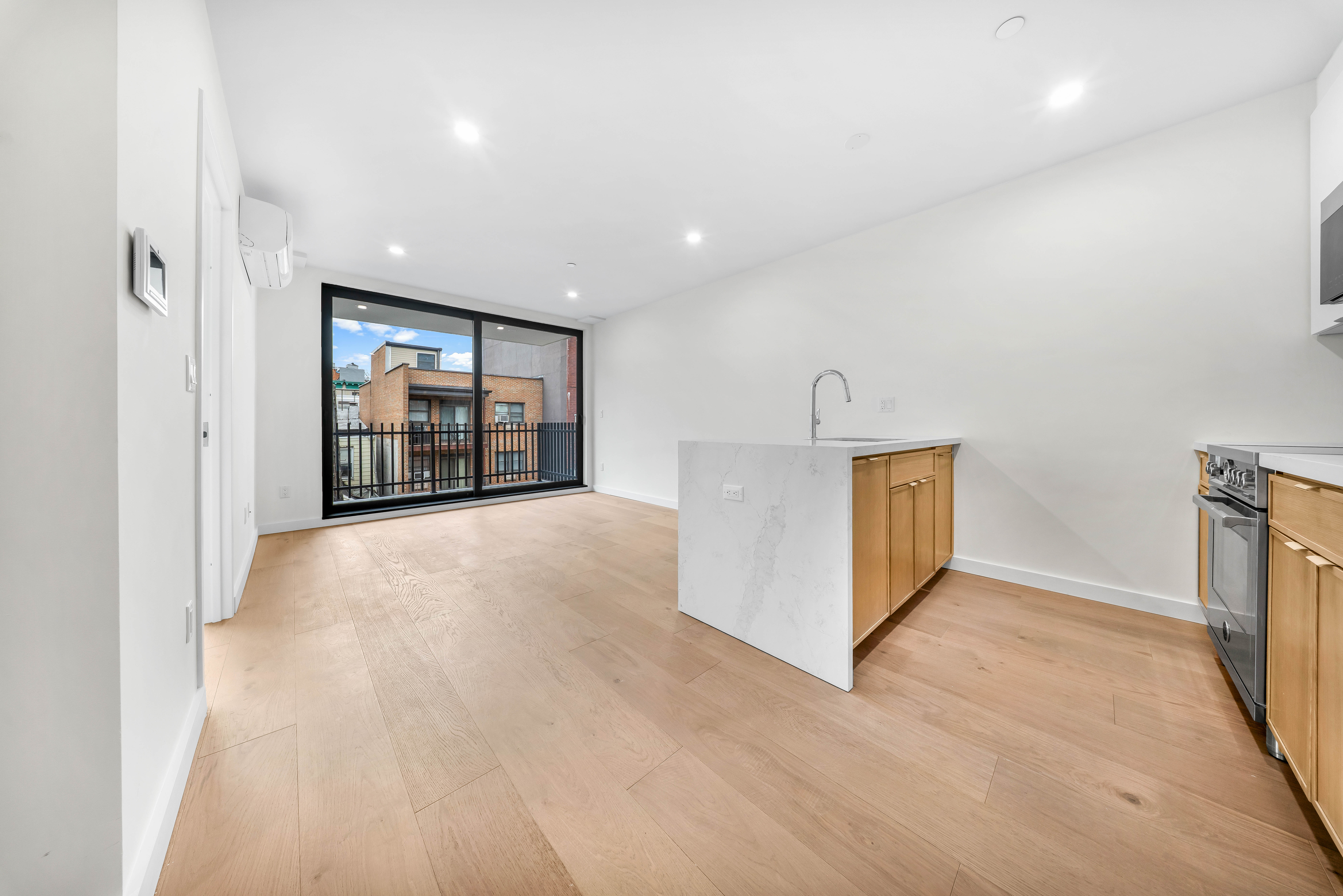 30-24 32nd Street, Unit 3A Queens, NY 11102 - Photo 17 of 18 a view of an empty room with a fireplace