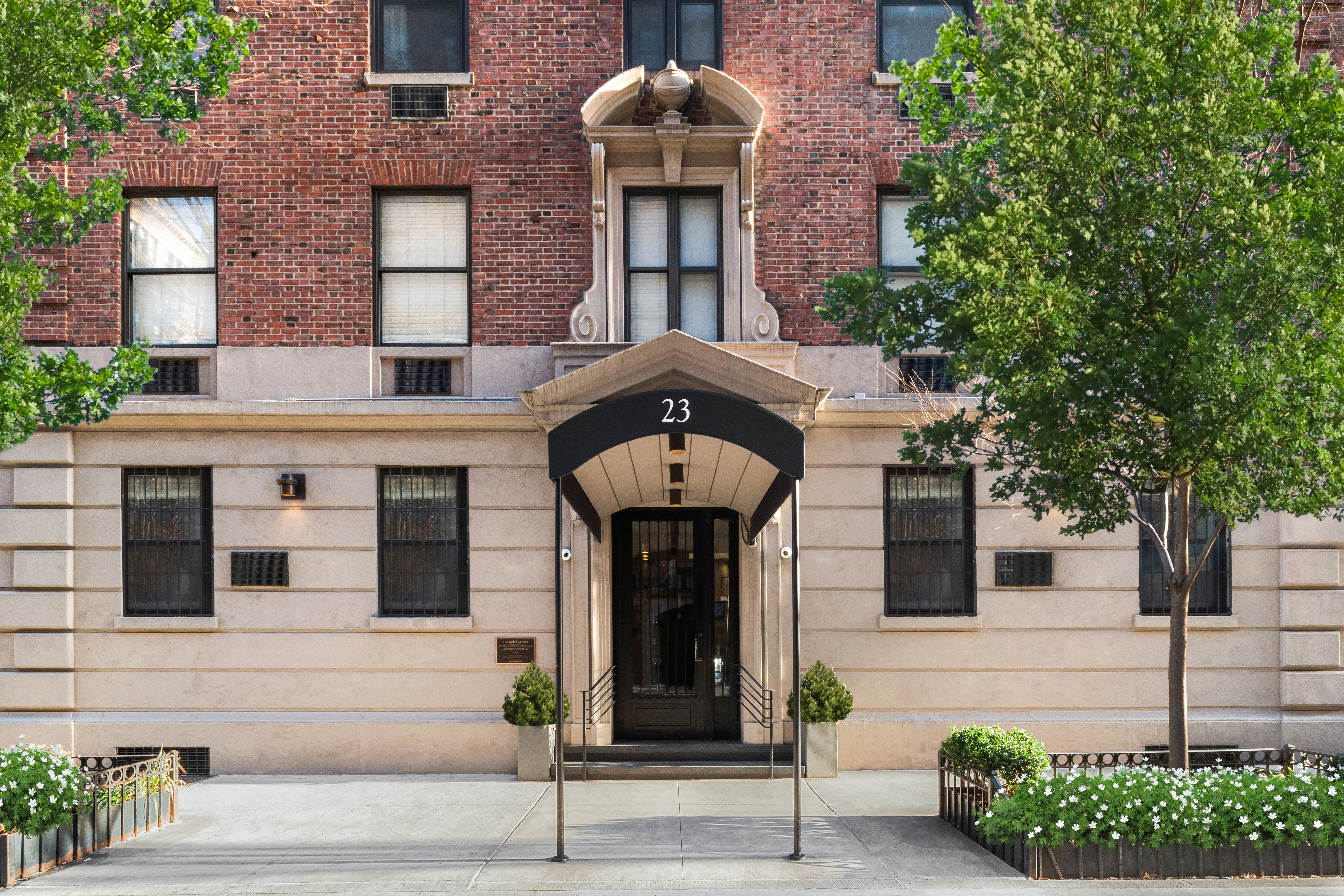 23 East 10th Street, Unit 3F Manhattan, NY 10003 - Photo 13 of 18 a front view of a building with a garden