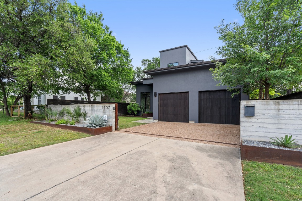 1207 East 13th Street Austin, TX 78702 - Photo 2 of 39 a front view of a house with a yard and garage