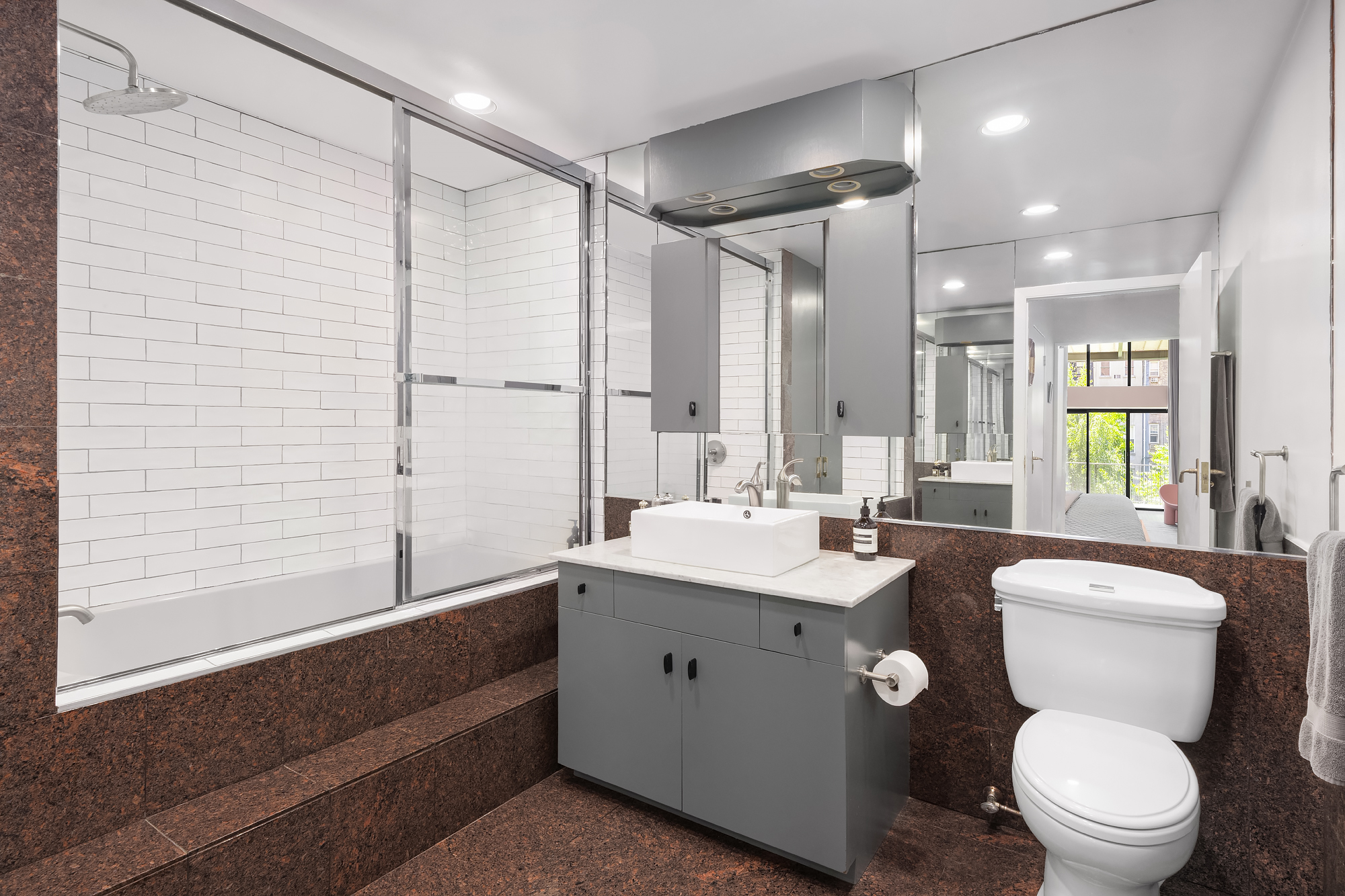 430 West 23rd Street, Unit C Manhattan, NY 10011 - Photo 14 of 16 a bathroom with a double vanity sink toilet and shower