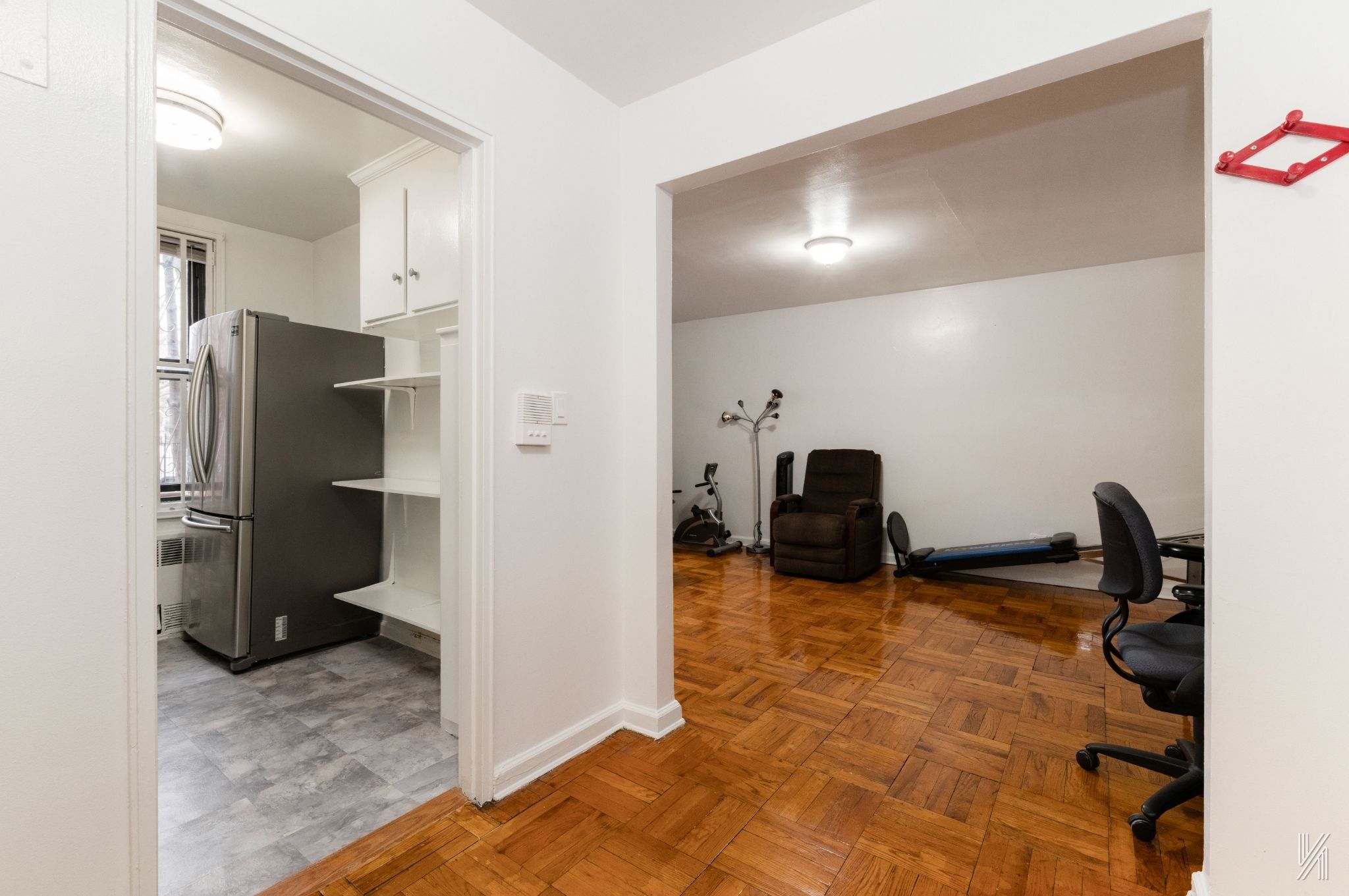 33-24 Junction Boulevard, Unit 1R Queens, NY 11372 - Photo 6 of 17 a view of a refrigerator in kitchen and utility room