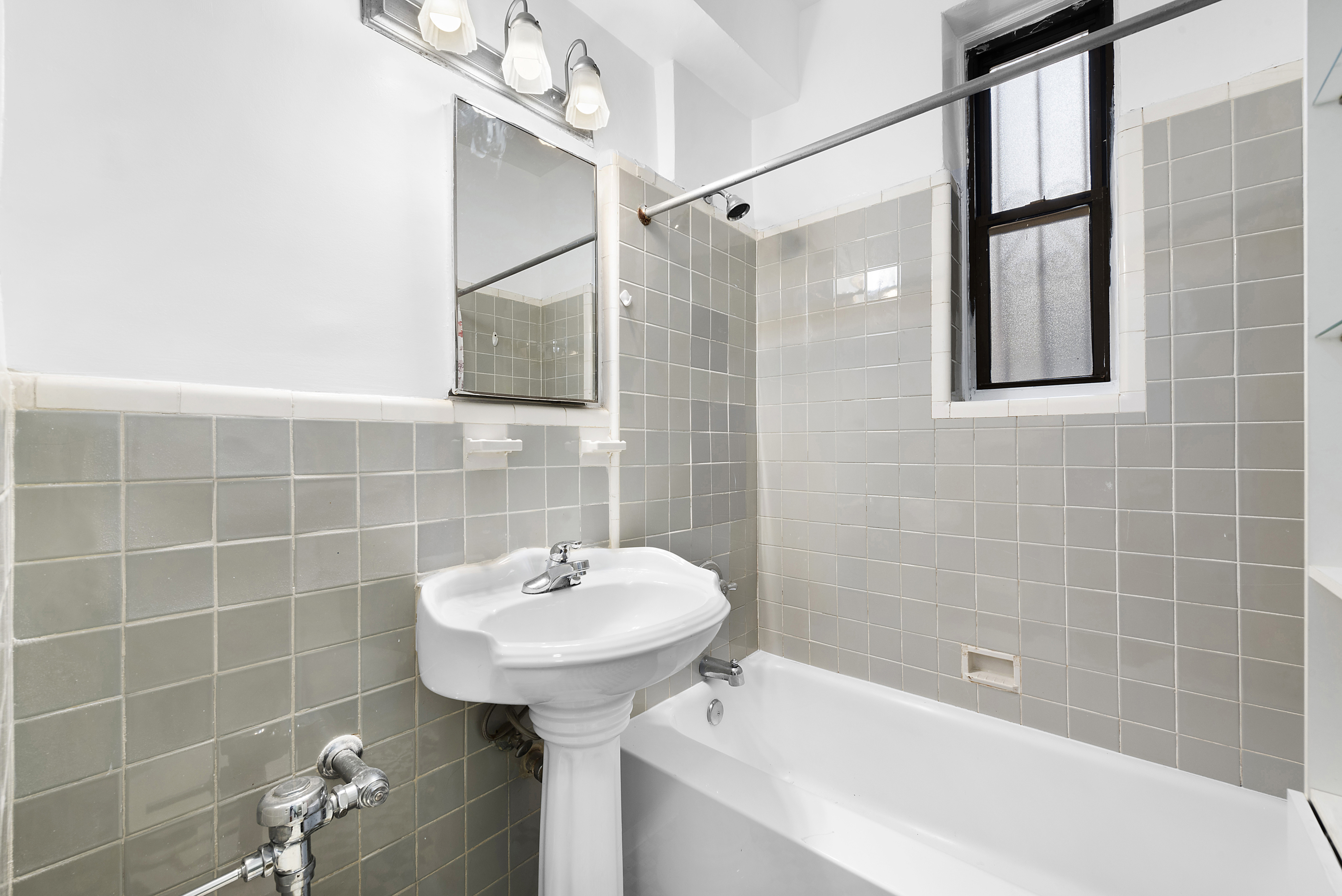 159-34 Riverside Drive West, Unit 1F90 Manhattan, NY 10032 - Photo 5 of 14 a bathroom with a sink and shower