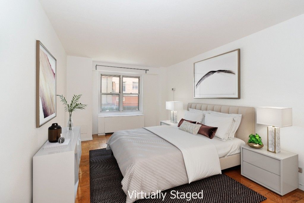 220 East 60th Street, Unit 2J Manhattan, NY 10022 - Photo 6 of 8 a bedroom with a bed a mirror and a window