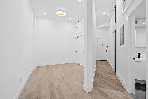 74 Leonard Street, Unit 4B Manhattan, NY 10013 - Photo 2 of 6 a view of a hallway with wooden floor and staircase
