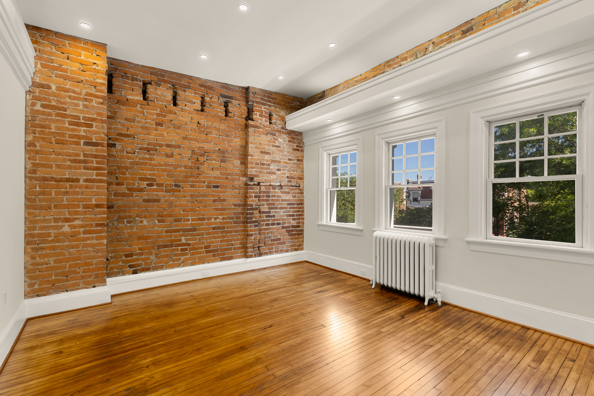1737 Park Road Northwest Washington, DC 20010 - Photo 14 of 32 a view of an empty room with wooden floor and a window