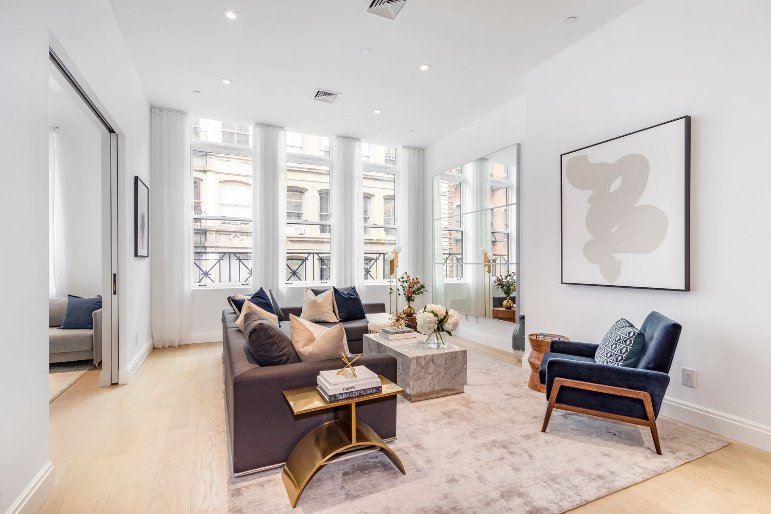 106 Franklin Street, Unit 2 Manhattan, NY 10013 - Photo 4 of 20 a living room with furniture and a large window