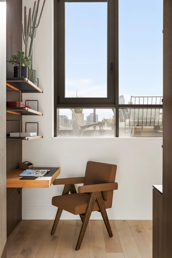 a reading room with furniture a rug and a window