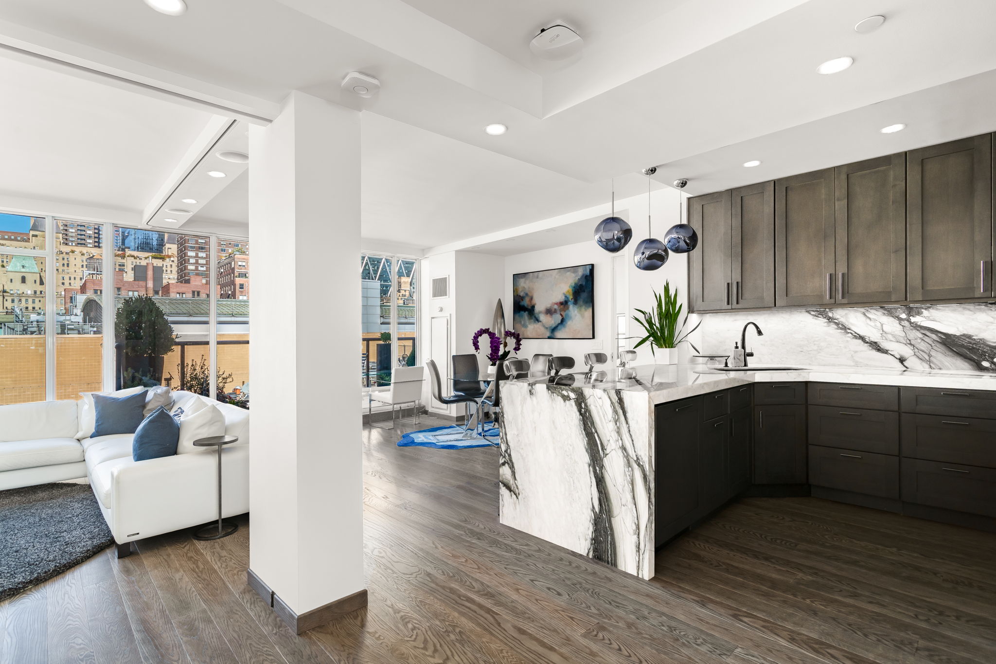 350 West 53rd Street, Unit PHB Manhattan, NY 10019 - Photo 8 of 34 a kitchen with a sink appliances and cabinets