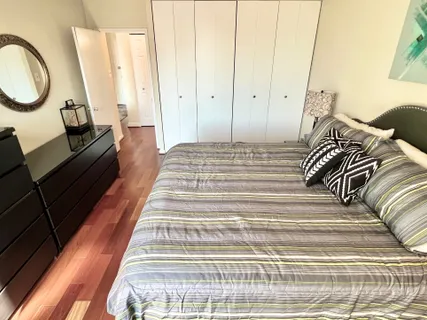 a bed sitting in a bedroom next to a window
