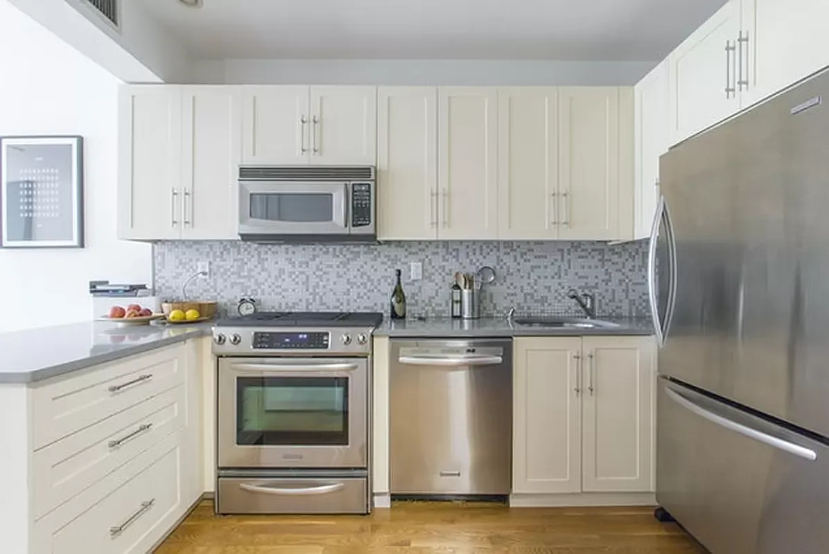 356 12th Street, Unit 2A Brooklyn, NY 11215 - Photo 3 of 7 a kitchen with granite countertop white cabinets and stainless steel appliances