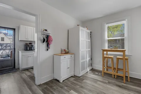 a kitchen with white cabinets and refrigerator