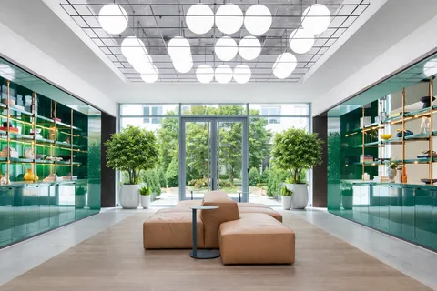 a living room with patio furniture and garden view