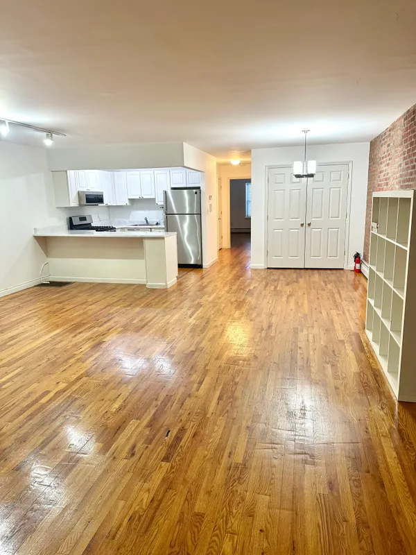 a view of kitchen and wooden floor