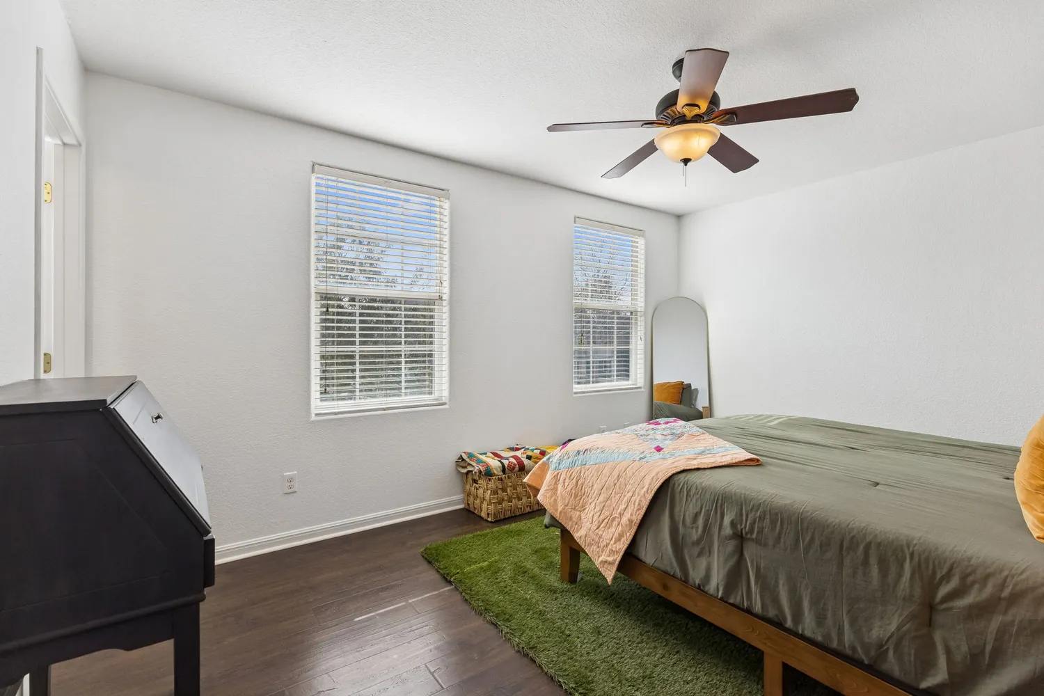 a bedroom with a bed and wooden floor