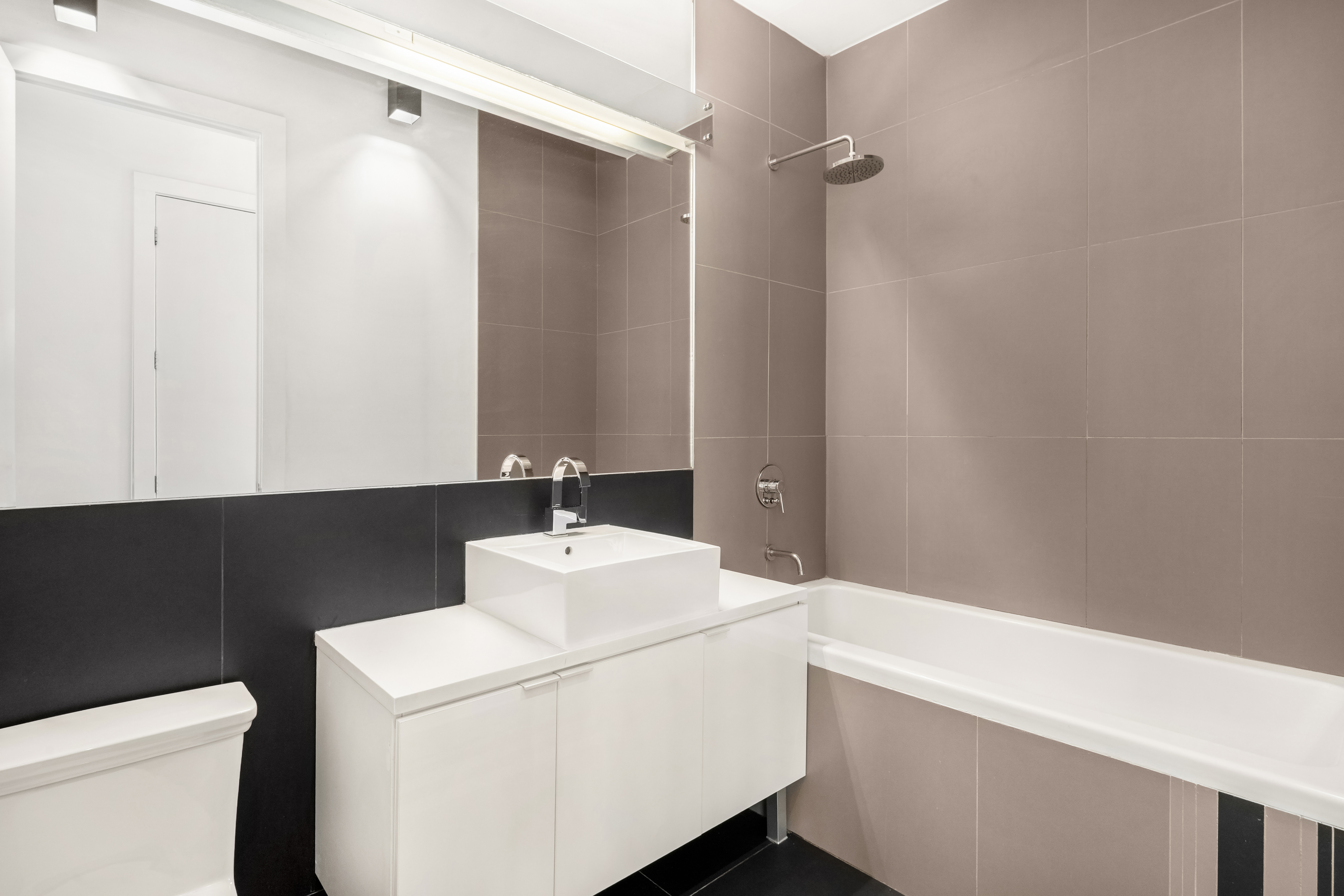 15 Roebling Street, Unit 2B Brooklyn, NY 11211 - Photo 6 of 9 a bathroom with a sink and a vanity