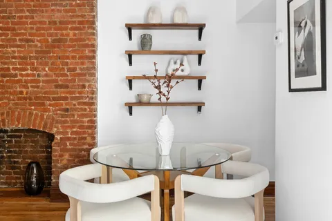 a dining room with table chairs and chandelier
