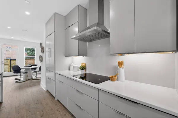 a kitchen with stainless steel appliances a sink a stove and cabinets